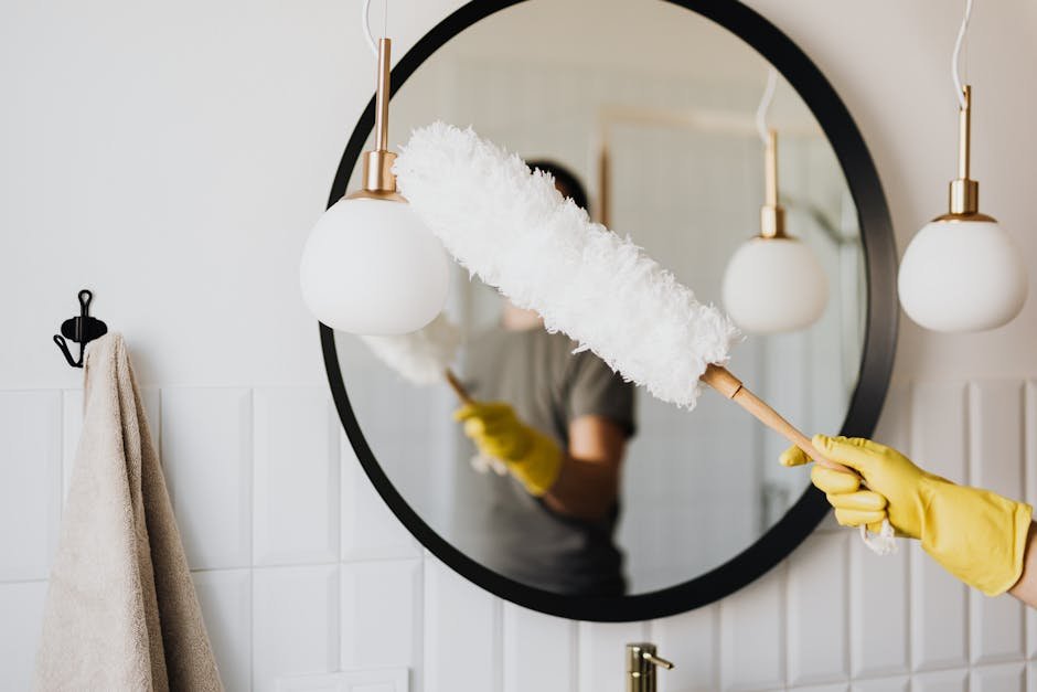 person cleaning mirror showcasing the benefits of professional move-out cleaning services